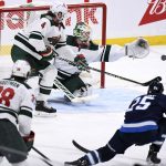 
              Minnesota Wild goaltender Kaapo Kahkonen (34) reaches for the puck after a shot by Winnipeg Jets' Paul Stastny (25) during the third period of an NHL game in Winnipeg, Manitoba, Tuesday, Feb. 8, 2022. (Fred Greenslade/The Canadian Press via AP)
            