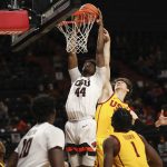 
              Oregon State forward Ahmad Rand dunks as Southern California guard Drew Peterson tries to block the shot during the second half of an NCAA college basketball game Thursday, Feb. 24, 2022, in Corvallis, Ore. Southern California won 94-91. (AP Photo/Amanda Loman)
            