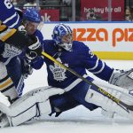 
              Toronto Maple Leafs goaltender Jack Campbell (36) makes a save on Pittsburgh Penguins forward Bryan Rust (17) as Maple Leafs defenseman Justin Holl (3) defends during the first period of an NHL hockey game Thursday, Feb. 17, 2022, in Toronto. (Nathan Denette/The Canadian Press via AP)
            