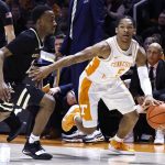 
              Tennessee guard Zakai Zeigler (5) drives against Vanderbilt guard Trey Thomas, left, during the first half of an NCAA college basketball game Saturday, Feb. 12, 2022, in Knoxville, Tenn. (AP Photo/Wade Payne)
            