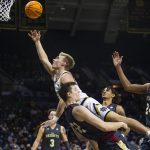 
              Notre Dame's Dane Goodwin (23) gets fouled by Boston College's Justin Vander Baan (32) during an NCAA college basketball game, Wednesday, Feb. 16, 2022 in South Bend, Ind. (Michael Caterina/South Bend Tribune via AP)
            