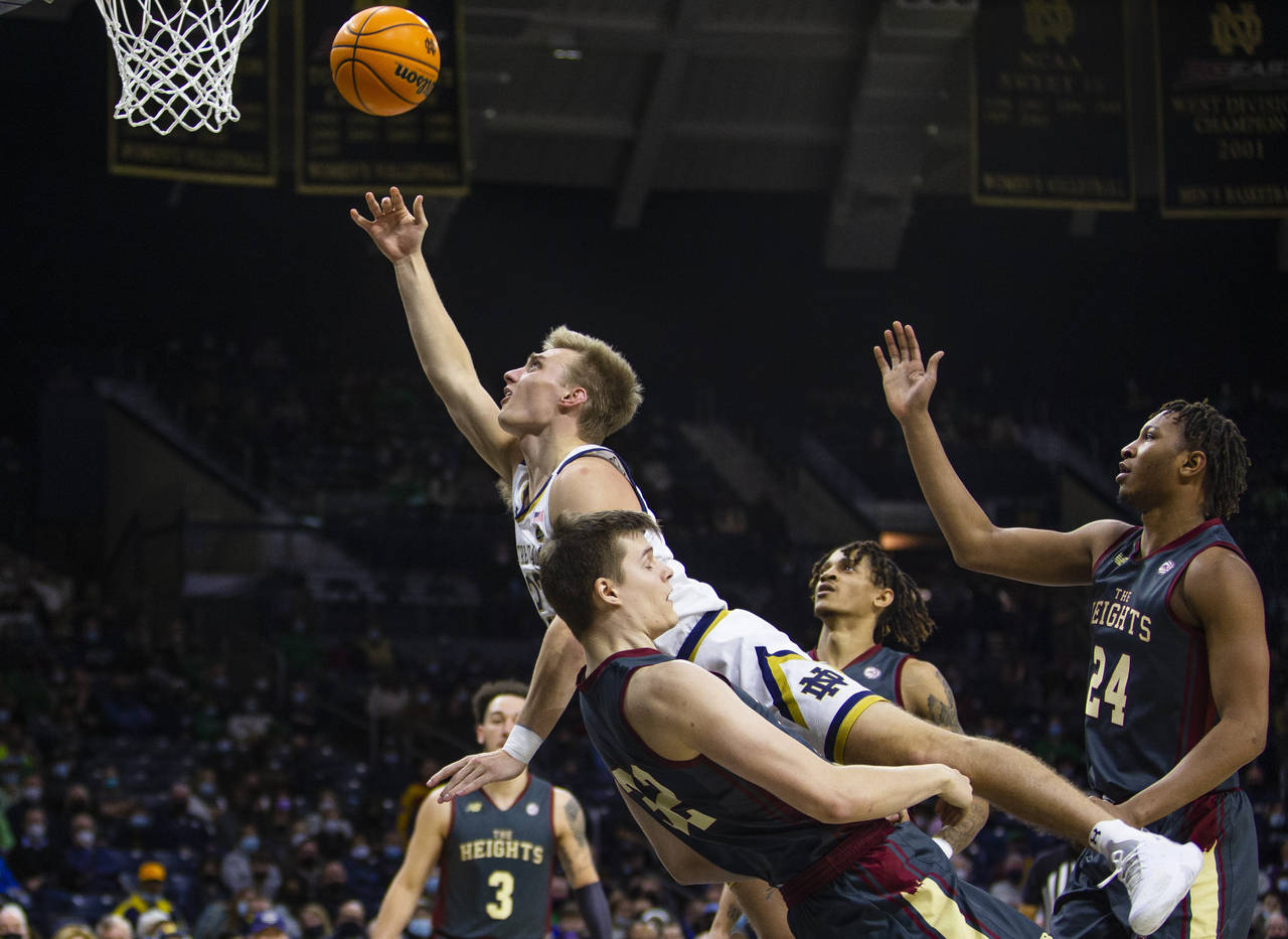 Notre Dame's Dane Goodwin (23) gets fouled by Boston College's Justin Vander Baan (32) during an NC...