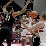
              Colorado forward Evan Battey (21) tries to block Stanford forward Harrison Ingram (55) who passes the ball to forward James Keefe (22) during the first half of an NCAA college basketball game in Stanford, Calif., Saturday, Feb. 19, 2022. (AP Photo/Nic Coury)
            