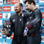 
              FILE- U.S. Steven Holcomb, left, and Carlo Valdes stand on the podium after the last run in the two-man bobsled competition at the Bob and Skeleton World Championships in Winterberg, Germany, Sunday, March 1, 2015. Five years since Holcomb was found dead in his room at the Olympic Training Center in Lake Placid, he is still felt within the program. “I definitely made my peace with him being gone a long time ago,” said Valdes, who used to push for Holcomb. “Now, it’s about how I can help people understand the type of person he was — especially the guys on the team now." (AP Photo/Michael Probst, File)
            