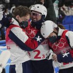
              United States' Justin Schoenefeld, center, celebrates with Christopher Lillis, left, and Ashley Caldwell during the mixed team aerials finals at the 2022 Winter Olympics, Thursday, Feb. 10, 2022, in Zhangjiakou, China. (AP Photo/Gregory Bull)
            