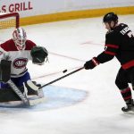 
              Ottawa Senators left wing Brady Tkachuk (7) is unable to tip the puck against Montreal Canadiens goaltender Andrew Hammond (37) during third-period NHL hockey game action in Ottawa, Ontario, Saturday, Feb. 26, 2022. (Justin Tang/The Canadian Press via AP)
            
