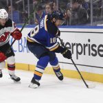 
              New Jersey Devils defenseman Ty Smith (24) defends against St. Louis Blues center Robert Thomas (18) during the second period of an NHL hockey game Thursday, Feb. 10, 2022, in St. Louis. (AP Photo/Joe Puetz)
            