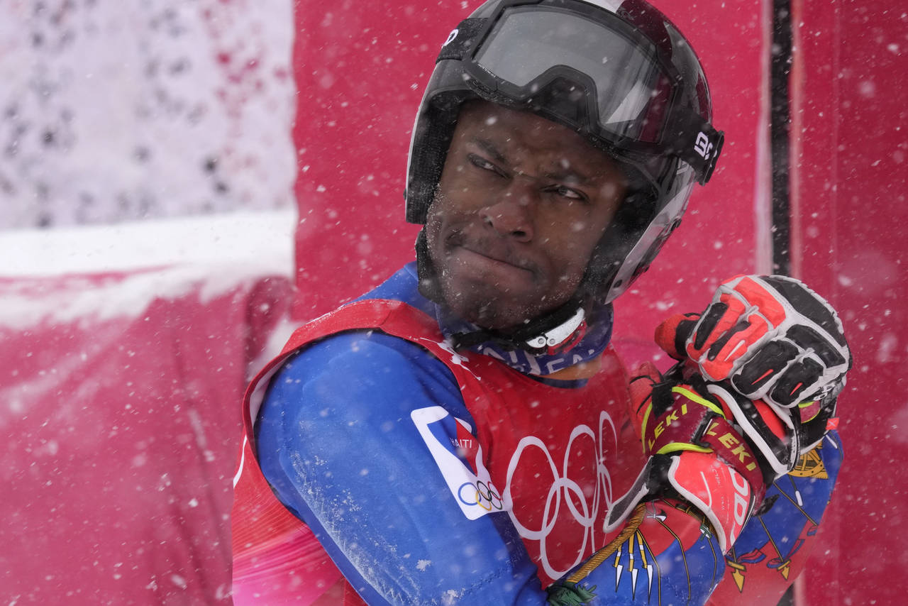 Richardson Viano, of Haiti reacts after finishing the first run of the men's giant slalom at the 20...