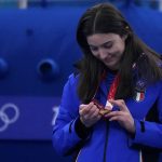 
              Italy's Stefania Constantini, looks at her gold medal, during the awards ceremony for the mixed doubles curling match against Norway, in the curling venue, at the 2022 Winter Olympics, Tuesday, Feb. 8, 2022, in Beijing. (AP Photo/Nariman El-Mofty)
            