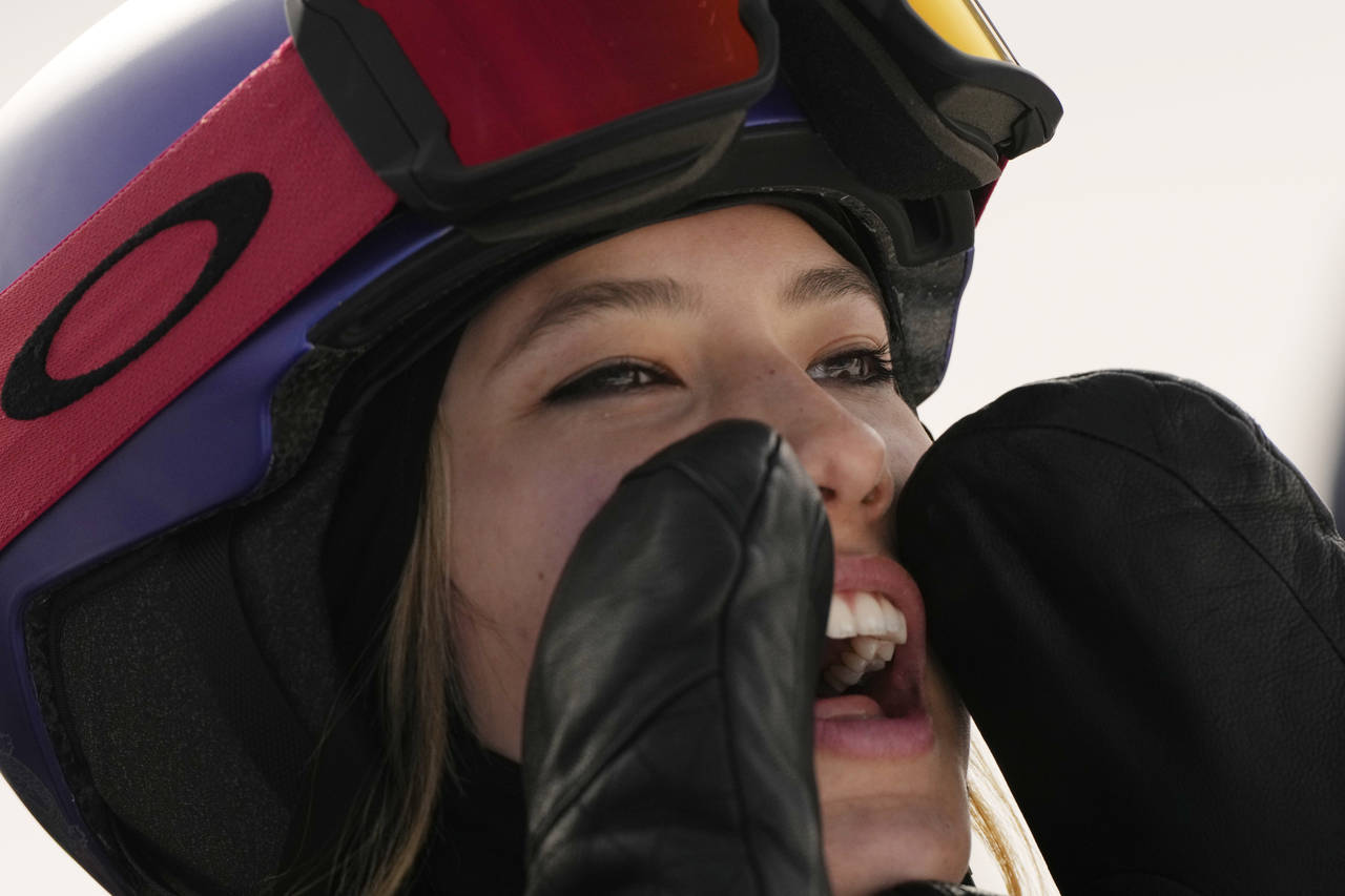 China's Eileen Gu cheers as United States' Chloe Kim competes during the women's halfpipe finals at...