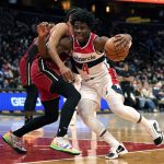 
              Washington Wizards guard Aaron Holiday (4) is defended by Miami Heat guard Gabe Vincent during the first half of an NBA basketball game, Monday, Feb. 7, 2022, in Washington. (AP Photo/Evan Vucci)
            