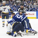 
              Toronto Maple Leafs' Michael Bunting center, fights with St. Louis Blues' Torey Krug, bottom, during second-period NHL hockey game action in Toronto, Saturday, Feb. 19, 2022. (Chris Young/The Canadian Press via AP)
            