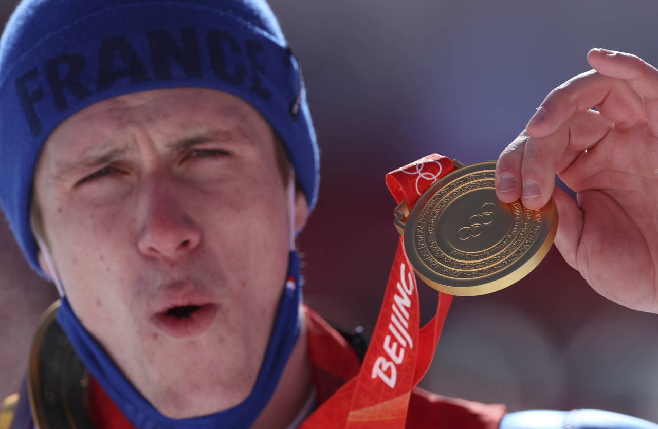 Clement Noel, of France holds his gold as he celebrates during the medal ceremony for the men's sla...