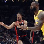 
              Portland Trail Blazers forward Trendon Watford, left, passes the ball as Los Angeles Lakers forward LeBron James, right, defends during the first half of an NBA basketball game in Portland, Ore., Wednesday, Feb. 9, 2022. (AP Photo/Steve Dipaola)
            