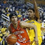 
              Illinois guard Andre Curbelo (5) drives to the basket past Michigan forward Terrance Williams II (5) during the first half of an NCAA college basketball game Sunday, Feb. 27, 2022, in Ann Arbor, Mich. (AP Photo/Duane Burleson)
            