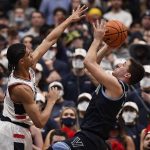 
              Villanova's Collin Gillespie, right, shoots over Connecticut's Andre Jackson during the second half of an NCAA college basketball game Tuesday, Feb. 22, 2022, in Hartford, Conn. (AP Photo/Jessica Hill)
            