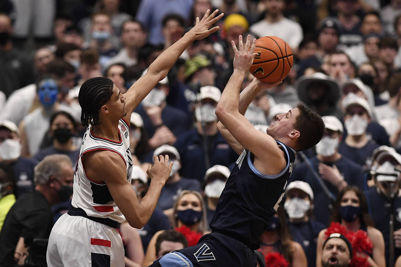 Villanova's Collin Gillespie, right, shoots over Connecticut's Andre Jackson during the second half...