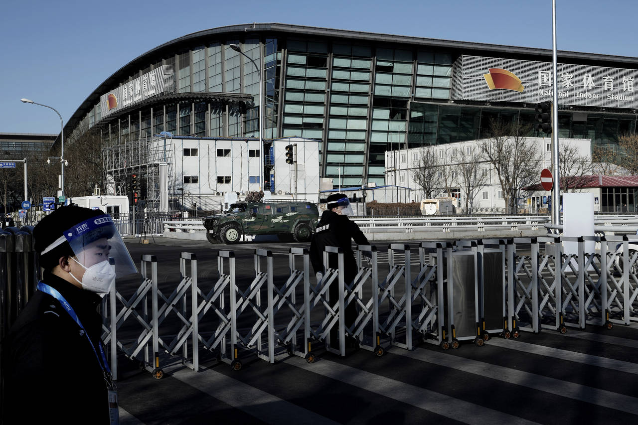Chinese security stand guard outside the National Indoor Stadium ahead of the 2022 Winter Olympics,...