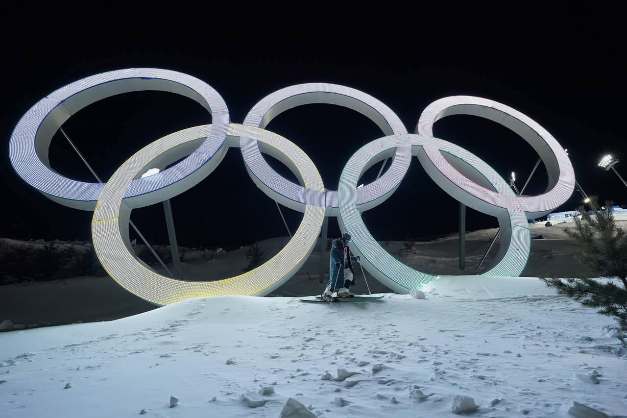 Switzerland's Marco Tade takes pictures by the Olympic rings during a training for the men's freest...
