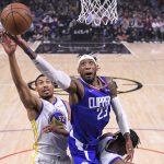 
              Los Angeles Clippers forward Robert Covington, right, shoots as Golden State Warriors forward Otto Porter Jr. defends during the first half of an NBA basketball game Monday, Feb. 14, 2022, in Los Angeles. (AP Photo/Mark J. Terrill)
            