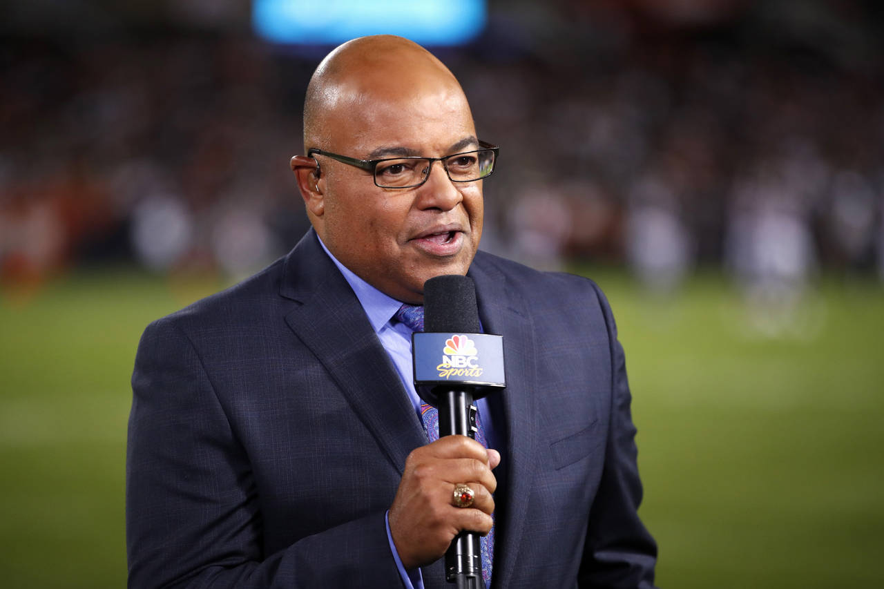 FILE - In this Sept. 5, 2019, file photo, NBC sportscaster Mike Tirico works the sidelines during a...