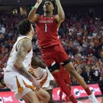 
              Texas Tech guard Terrence Shannon Jr. (1) shoots over Texas forward Christian Bishop (32) during the first half of an NCAA college basketball game, Saturday, Feb. 19, 2022, in Austin, Texas. (AP Photo/Eric Gay)
            