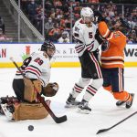 
              Chicago Blackhawks goalie Marc-Andre Fleury (29) makes a save as Edmonton Oilers' Evander Kane (91) and Connor Murphy (5) battle in front of the net during the second period of an NHL hockey game Wednesday, Feb. 9, 2022, in Edmonton, Alberta. (Jason Franson/The Canadian Press via AP)
            
