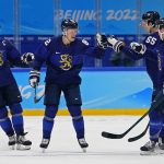 
              Finland's Harri Pesonen (82) is congratulated by Atte Ohtamaa (55) and Ville Pokka (2) after scoring a goal against Slovakia during a men's semifinal hockey game at the 2022 Winter Olympics, Friday, Feb. 18, 2022, in Beijing. Finland won 2-0. (AP Photo/Matt Slocum)
            