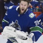 
              Vancouver Canucks goalie Thatcher Demko reacts after using smelling salts before the team's NHL hockey game against the Arizona Coyotes on Tuesday, Feb. 8, 2022, in Vancouver, British Columbia. (Darryl Dyck/The Canadian Press via AP)
            