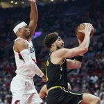 
              Golden State Warriors guard Klay Thompson, right, shoots in front of Portland Trail Blazers guard Josh Hart during the first half of an NBA basketball game in Portland, Ore., Thursday, Feb. 24, 2022. (AP Photo/Craig Mitchelldyer)
            