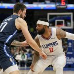
              Los Angeles Clippers forward Marcus Morris Sr. (8) is defended by Dallas Mavericks guard Luka Doncic (77) during the first quarter of an NBA basketball game in Dallas, Saturday, Feb. 12, 2022. (AP Photo/LM Otero)
            