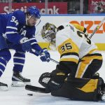 
              Pittsburgh Penguins goaltender Tristan Jarry (35) stops Toronto Maple Leafs forward Auston Matthews (34) during the second period of an NHL hockey game Thursday, Feb. 17, 2022, in Toronto. (Nathan Denette/The Canadian Press via AP)
            