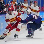 
              China's Fu Jiang (Parker Foo) (15) and United States' Ben Meyers (39) play during a preliminary round men's hockey game at the 2022 Winter Olympics, Thursday, Feb. 10, 2022, in Beijing. (AP Photo/Matt Slocum)
            