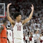 
              Arkansas forward Jaylin Williams (10) gets the crowd pumped up after scoring against Auburn during overtime in an NCAA college basketball game Tuesday, Feb. 8, 2022, in Fayetteville, Ark. (AP Photo/Michael Woods)
            