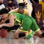
              Oregon guard Will Richardson, front, battles Arizona State forward Alonzo Gaffney for the loose ball during the second half of an NCAA college basketball game, Thursday, Feb. 17, 2022, in Tempe, Ariz. (AP Photo/Matt York)
            