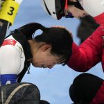 
              Nana Takagi of Team Japan is comforted by teammates after falling during the speedskating women's team pursuit finals at the 2022 Winter Olympics, Tuesday, Feb. 15, 2022, in Beijing. (AP Photo/Ashley Landis)
            