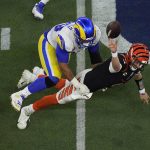 
              Los Angeles Rams defensive end Aaron Donald (99) forces Cincinnati Bengals quarterback Joe Burrow (9) to throw an incomplete pass during the second half of the NFL Super Bowl 56 football game Sunday, Feb. 13, 2022, in Inglewood, Calif. (AP Photo/Matt Rourke)
            