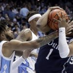 
              North Carolina guard R.J. Davis (4) and Duke guard Trevor Keels (1) fight for a loose ball during the second half of an NCAA college basketball game, Saturday, Feb. 5, 2022, in Chapel Hill, N.C. (AP Photo/Chris Seward)
            