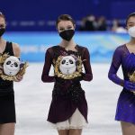 
              Gold medalist Anna Shcherbakova, centre, of the Russian Olympic Committee, stands with silver medalist and compatriot Alexandra Trusova, left, and bronze medalist Kaori Sakamoto, of Japan, following the women's free skate program during the figure skating competition at the 2022 Winter Olympics, Thursday, Feb. 17, 2022, in Beijing. (AP Photo/David J. Phillip)
            