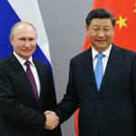 
              FILE - Russian President Vladimir Putin, left, and China's President Xi Jinping shake hands prior to their talks on the sideline of the 11th edition of the BRICS Summit, in Brasilia, Brazil in Nov. 12, 2019. Amid the soaring tensions over Ukraine, President Vladimir Putin is heading to Beijing on a trip intended to help strengthen Russia's ties with China and coordinate their policies amid Western pressure. (Ramil Sitdikov, Sputnik, Kremlin Pool Photo via AP, File)
            