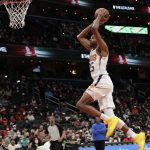 
              Phoenix Suns' Mikal Bridges dunks during the first half of an NBA basketball game against the Washington Wizards, Saturday, Feb. 5, 2022, in Washington. (AP Photo/Luis M. Alvarez)
            