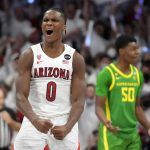 
              Arizona guard Bennedict Mathurin (0) reacts after scoring against Oregon during the first half of an NCAA college basketball game, Saturday, Feb. 19, 2022, in Tucson, Ariz. (AP Photo/Rick Scuteri)
            