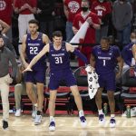 
              Players and coaches on the Northwestern sideline celebrate a basket against Nebraska during the second half of an NCAA college basketball game Saturday, Feb. 5, 2022, in Lincoln, Neb. Northwestern defeated Nebraska 87-63. (AP Photo/Rebecca S. Gratz)
            