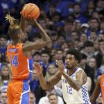 
              Florida's Kowacie Reeves (14) shoots over Kentucky's Keion Brooks Jr. (12) during the first half of an NCAA college basketball game in Lexington, Ky., Saturday, Feb. 12, 2022. (AP Photo/James Crisp)
            
