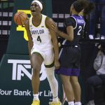 
              Baylor center Queen Egbo reacts to being fouled, next to Kansas State guard Cymone Goodrich, right, during the first half of an NCAA college basketball game Wednesday, Feb. 9, 2022, in Waco, Texas. (Rod Aydelotte/Waco Tribune-Herald via AP)
            