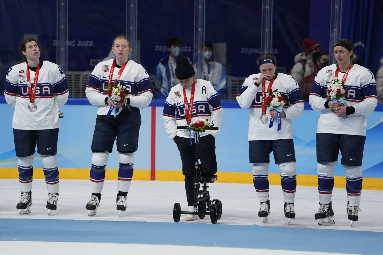 United States pose for photos after receiving their silver medals after being defeated by Canada in...