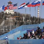 
              Spectators watch the women's freestyle skiing Big Air qualification round of the 2022 Winter Olympics, Monday, Feb. 7, 2022, in Beijing. (AP Photo/Jae C. Hong)
            