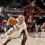 
              Stanford forward Cameron Brink, left, collides with Washington State center Bella Murekatete (55) during the first half of an NCAA college basketball game Thursday, Feb. 24, 2022, in Stanford, Calif. (AP Photo/John Hefti)
            