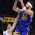 
              Golden State Warriors guard Klay Thompson (11) shoots over Oklahoma City Thunder guard Josh Giddey (3) in the first half of an NBA basketball game, Monday, Feb. 7, 2022, in Oklahoma City. (AP Photo/Kyle Phillips)
            