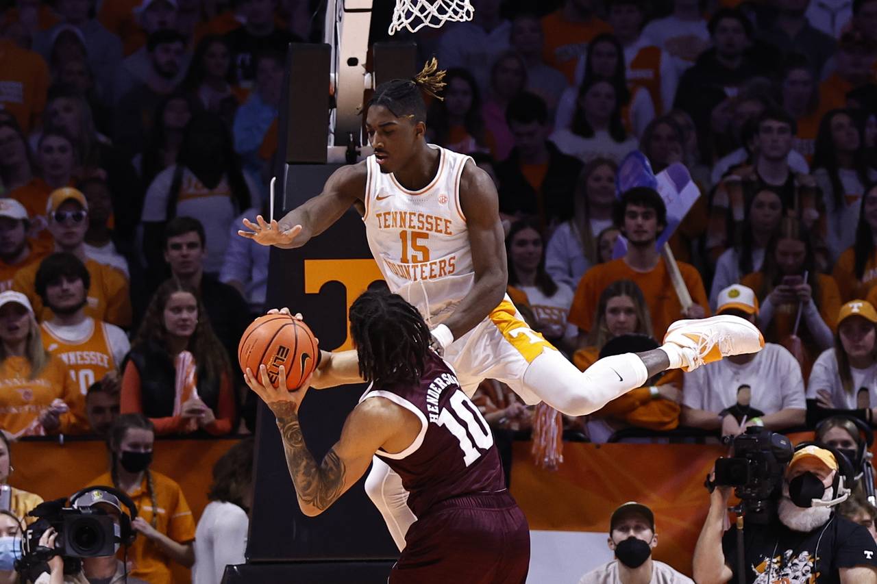 Tennessee guard Jahmai Mashack (15) flies over Texas A&M guard Aaron Cash (0) while defending durin...